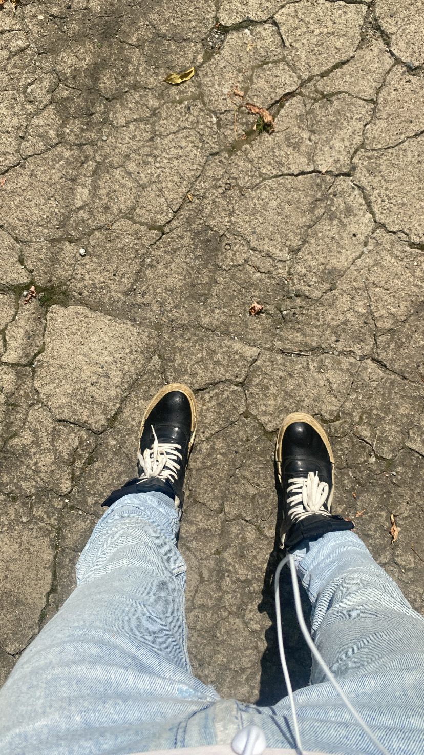 Black high-tops on cracked concrete